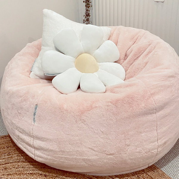 Soft white daisy-designed cushion for kids, ideal for brightening up a child's bedroom or play area.