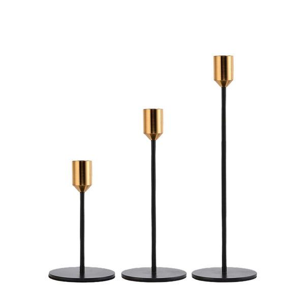 brass and black candlestick set on a white background