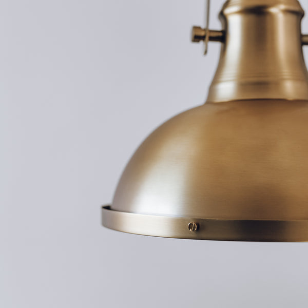 Close up detail of Amani pendant light in gold. 
