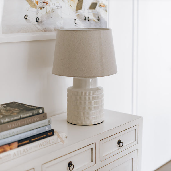 Quinn ceramic ribbed table lamp with beige linen shade.