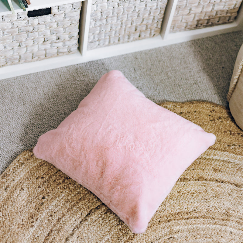 An elegant pink faux fur cushion, providing a plush and luxurious feel for ultimate comfort