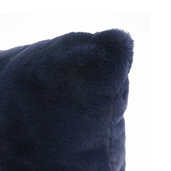 Plush navy cushion displayed on a sofa, adding a touch of elegance to the room's decor.