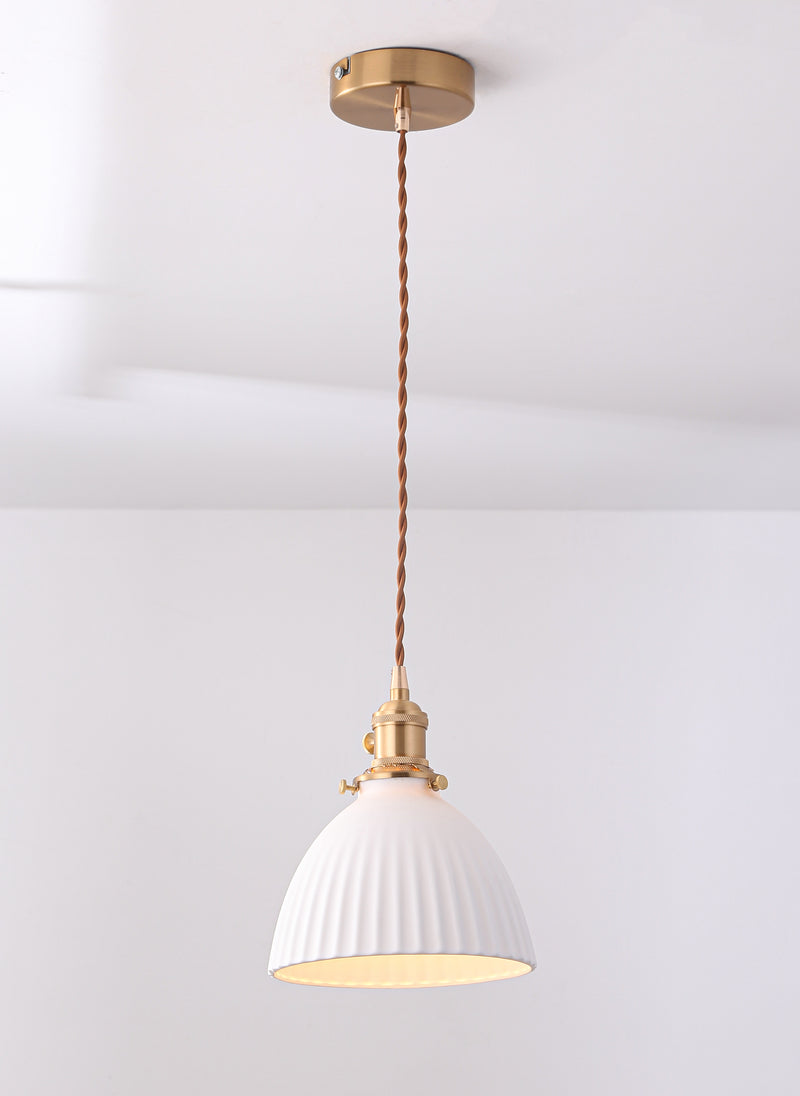 Pleated ceramic pendant light with brass gold fixture.