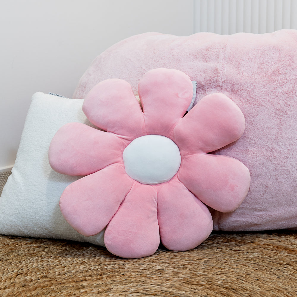 Soft pink daisy-designed cushion for kids, perfect for adding a touch of floral charm to children's rooms