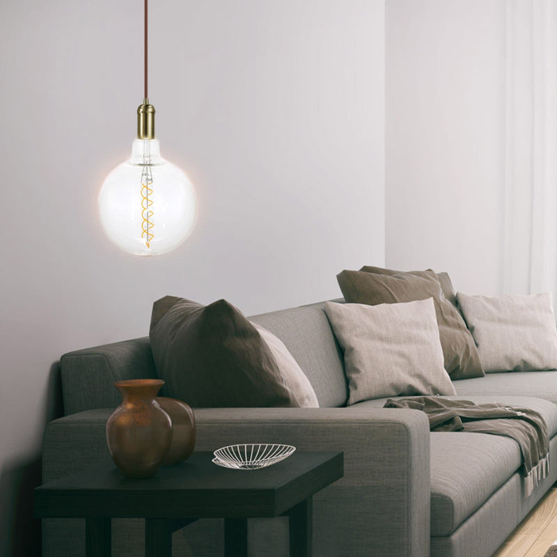 oversize filament globe with single spiral 4w hanging in a living room