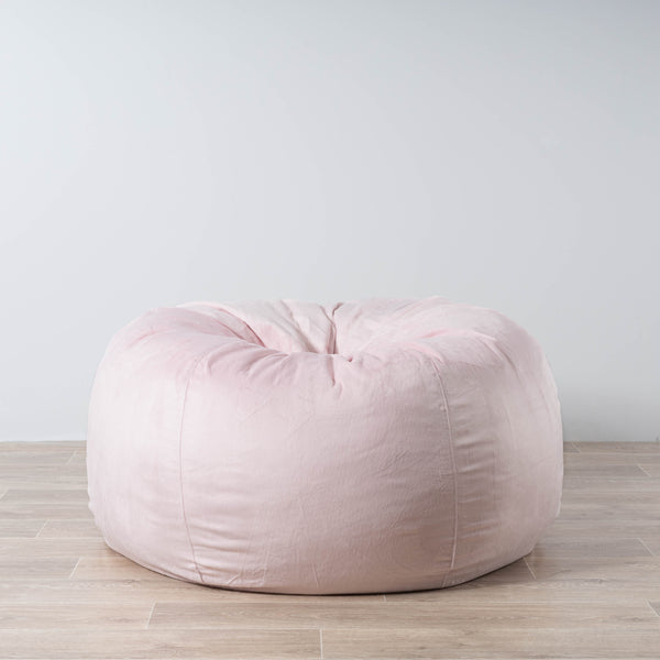 soft pink velvet fur beanbag on a wooden floor