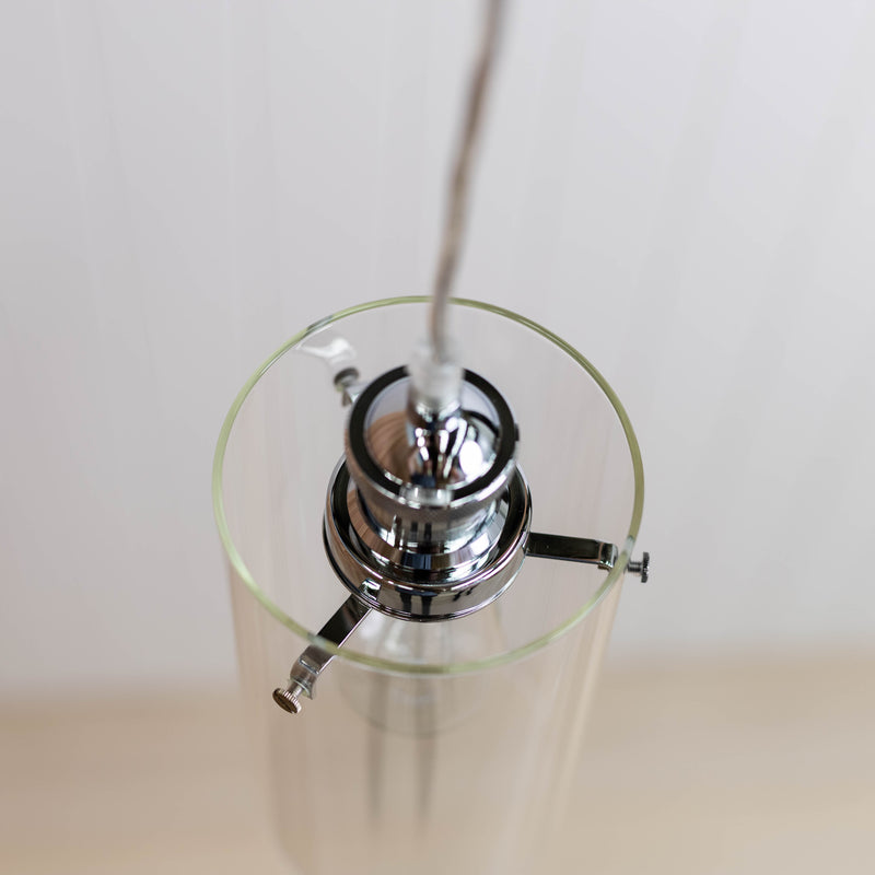 chrome detail on a glass pendant light allira