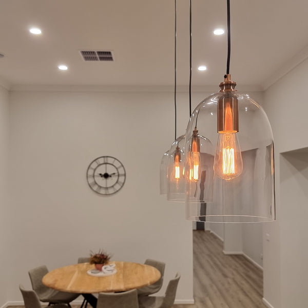 glass pendant light with copper hardware in a modern kitchen