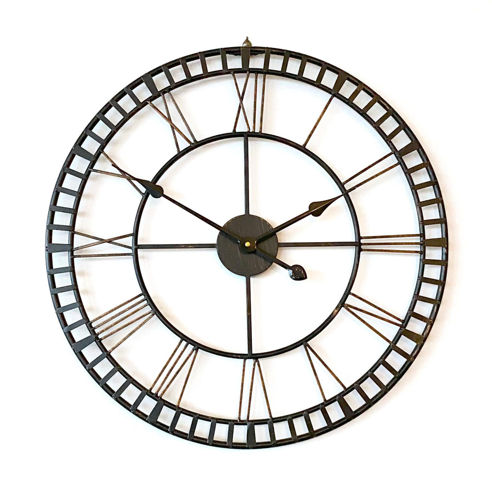 provincial look distressed metal wall clock on a white wall