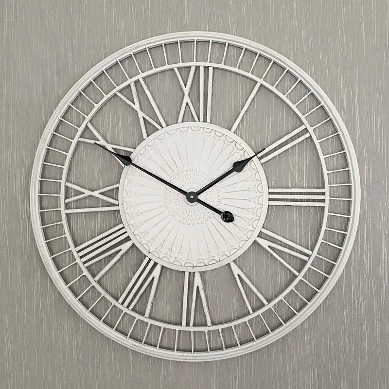 shabby cream clock on a textured wall