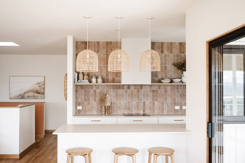 3 large natural rattan pendant lights in a modern organic kitchen