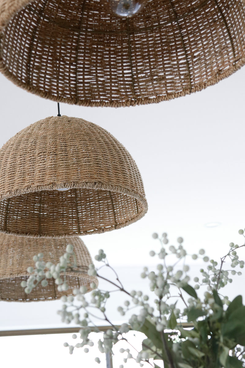 villa pendant light made with rope hanging in a white kitchen with white blossoms