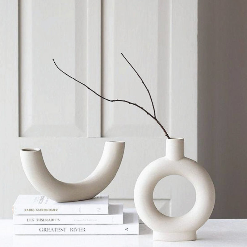 home decor modern ceramic vase on a pile of coffee table books