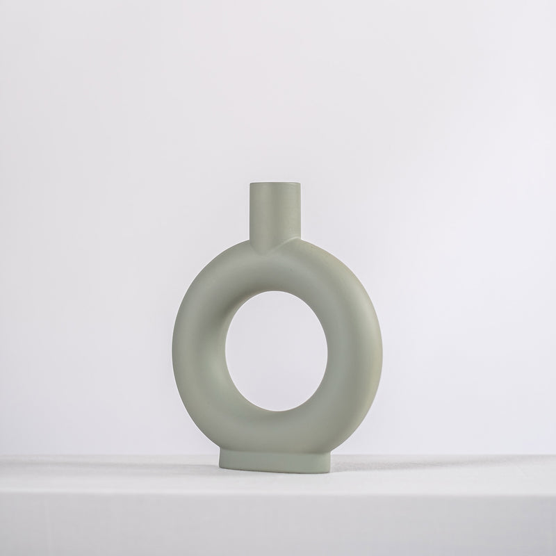 modern sage ceramic vase on a white shelf