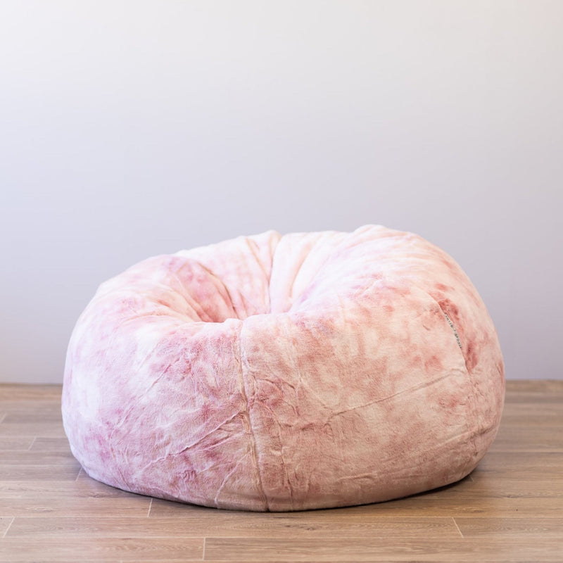 plush pink marble beanbag on a wooden floor