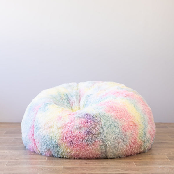 large shaggy fur unicorn rainbow beanbag on a wooden floor  Edit alt text