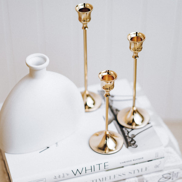 Gold candle stick holders on book