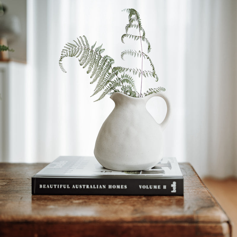 ceramic vase vessel on a coffee table book