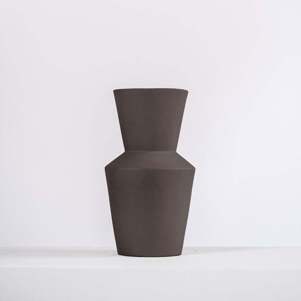 modern black ceramic vase on a white shelf