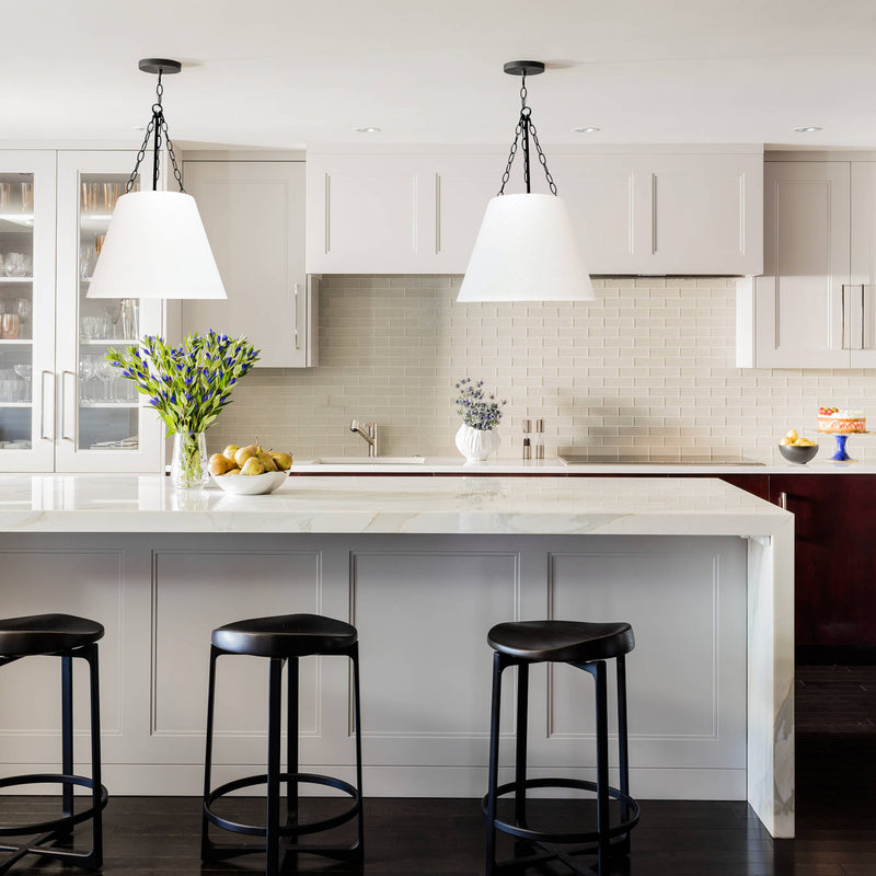conical pendant light with black hardware in a kitchen