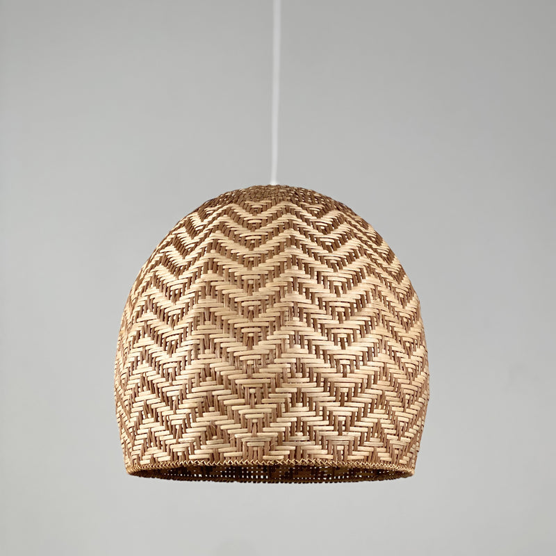 Rattan pendant light in a dome shape, designed to resemble a sunset. This light fixture exudes a Bali-inspired ambiance, with warm, sunset-like hues woven through the natural rattan material, creating a soft and inviting glow.