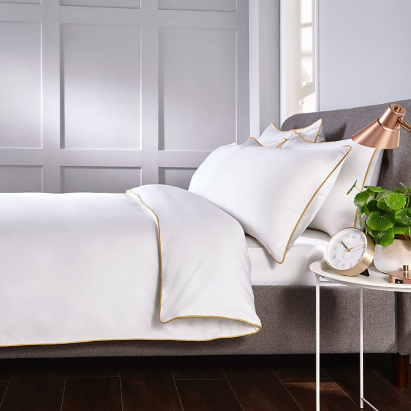 white quilt cover with gold piping edging trim
