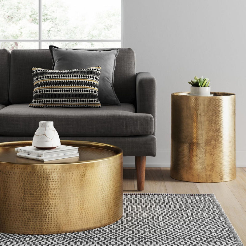 hammered brass drum side table in a modern living room