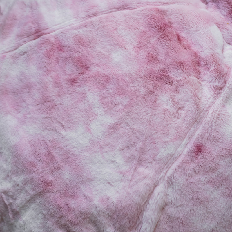 close up of a plush pink marble beanbag on a wooden floor