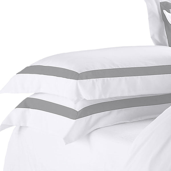 Soft white pillows on a neatly made bed in a modern bedroom setting