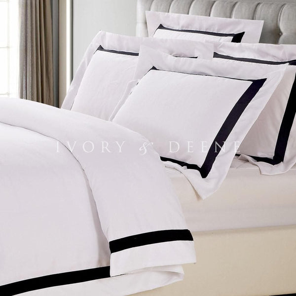white ava quilt cover with black trim with quilted bedhead