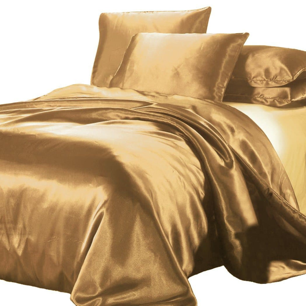 satin quilt cover gold with pillows on white background