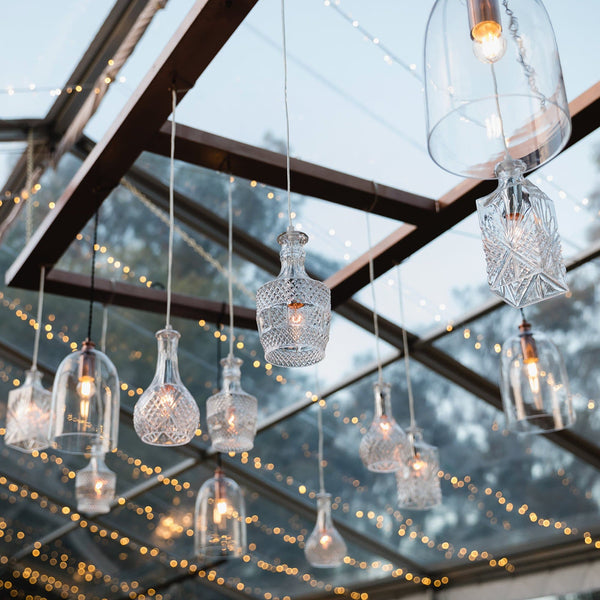 wine decanter glass pendant lights hanging in a reception venue
